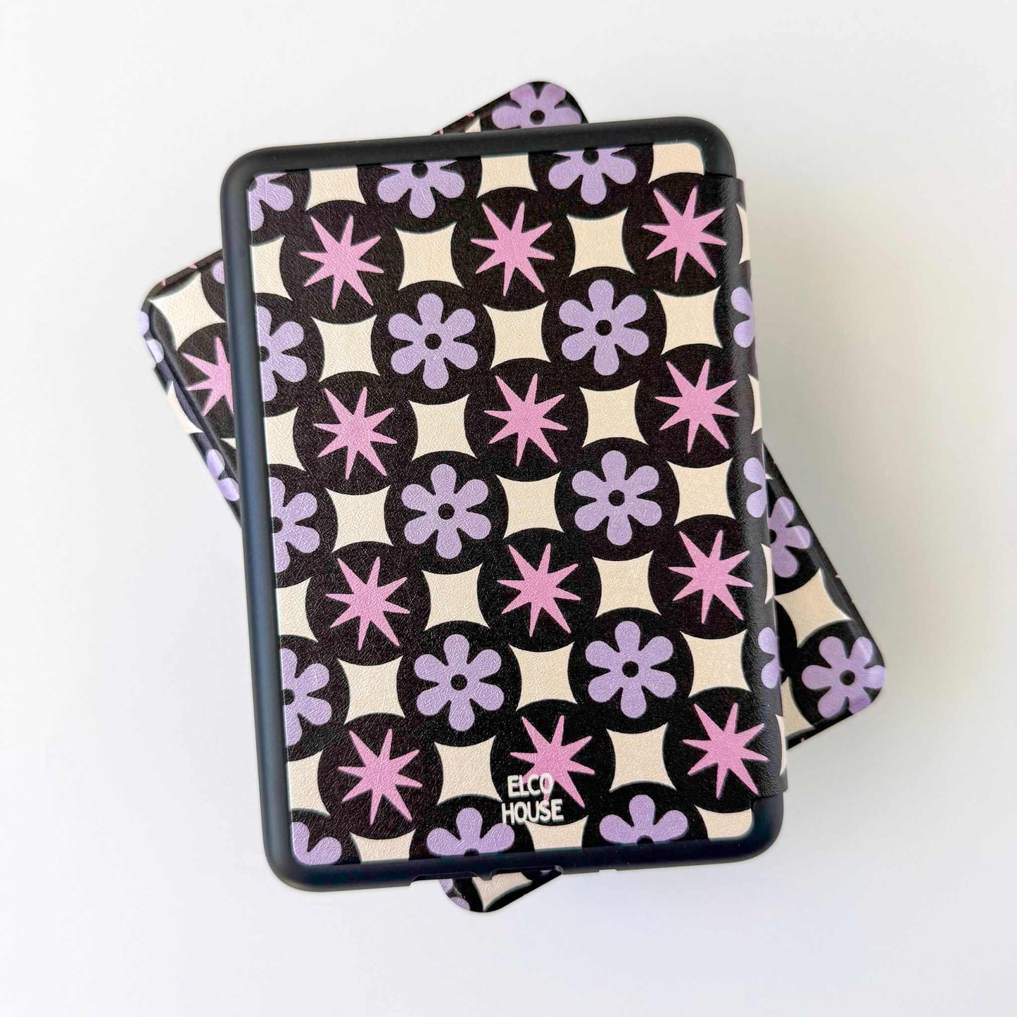 Patterned Kindle case product with 'ELCO HOUSE' branding on a white background