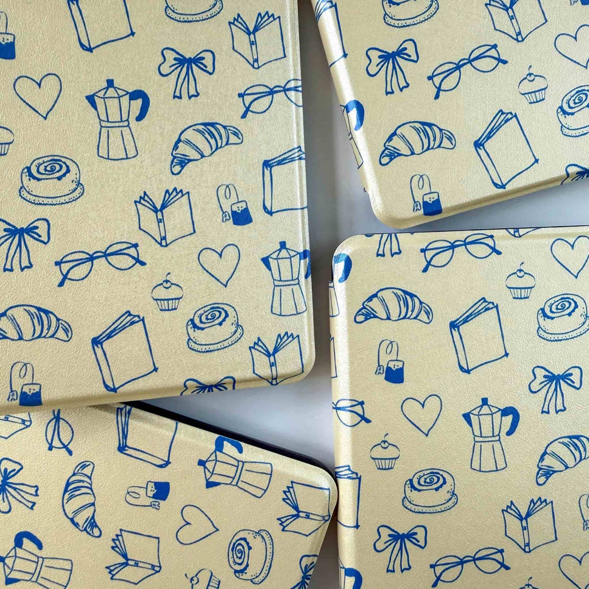 Yellow kindle cases with blue all over print, on a white background 