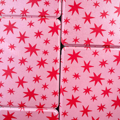 pink kindle cases printed with red stars, arranged in a tiled pattern 