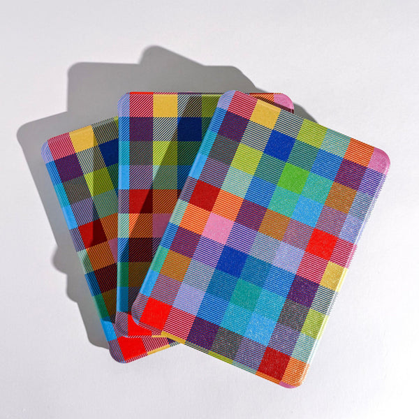 A stack of kindle cases featuring a colorful plaid design