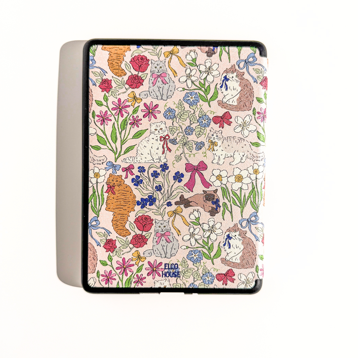 A Kindle Case featuring a colorful floral and animal print on a light pink background. The print includes illustrated flowers, butterflies, and cats in red, blue, green, orange, and brown.