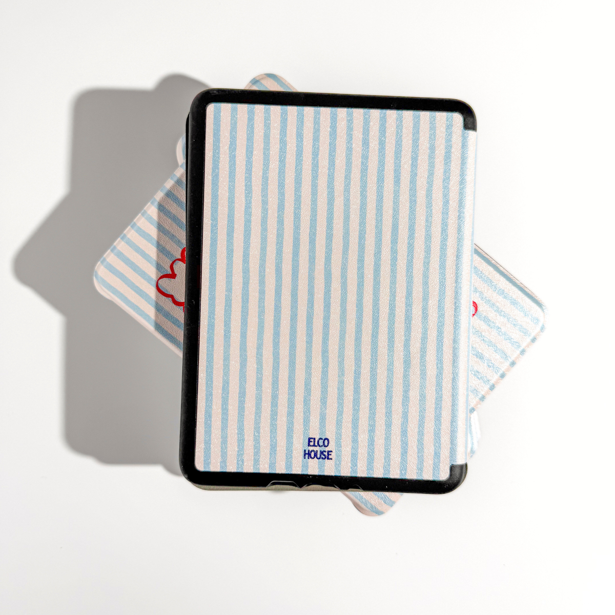 A Kindle case with a light blue and white vertical stripe pattern, featuring a black border and the 'ELCO HOUSE' brand logo near the bottom, displayed on a clean white background with a soft shadow.