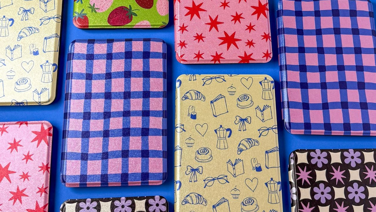 Collection of colorful patterned Kindle cases on a blue background