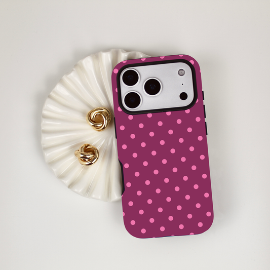 iPhone phone case with pink polka dots on a white background