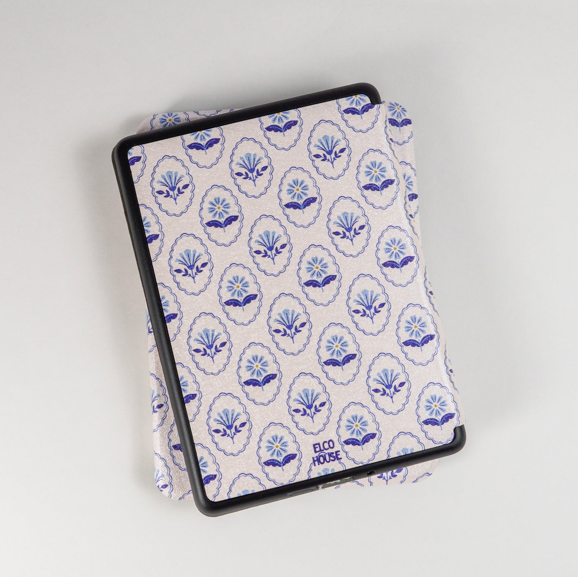 Back of Bloom Service Kindle Case showing repeating floral pattern with framed flowers and elco house logo 