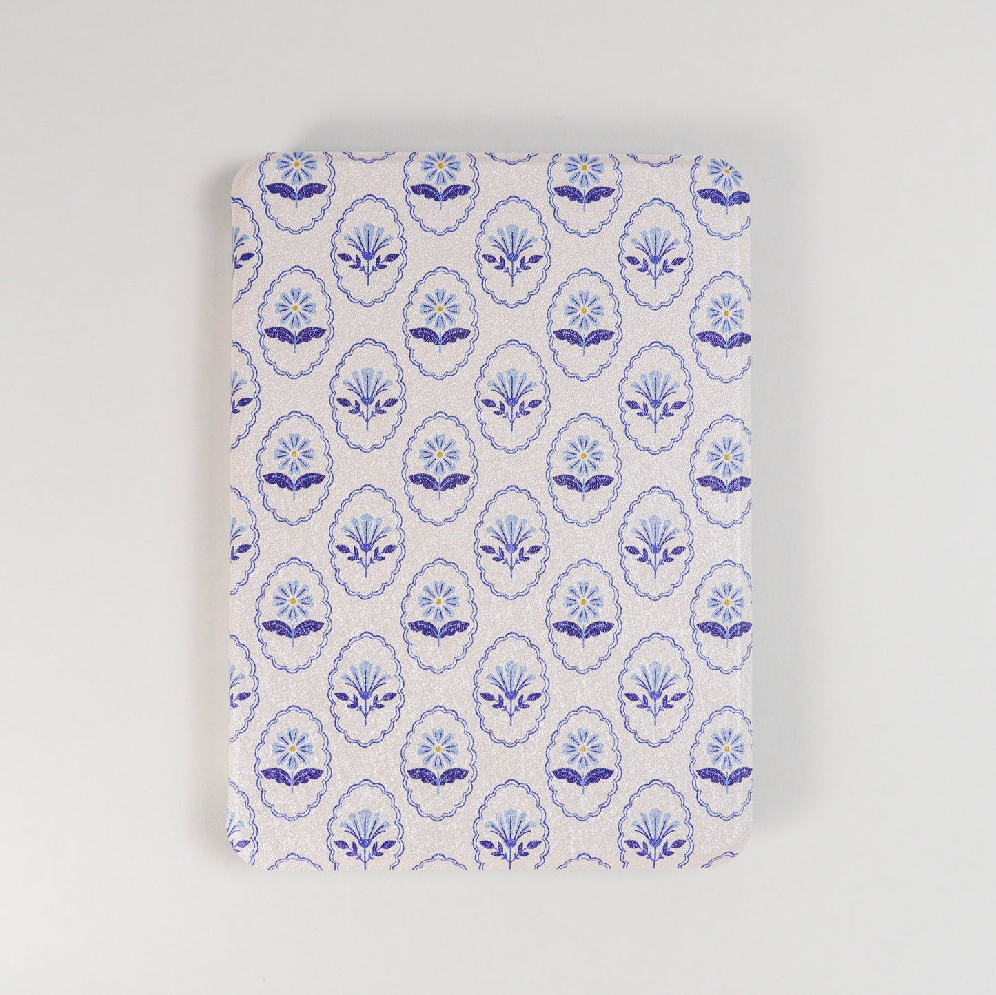 Bloom Service Kindle Case with repeating blue floral pattern and framed flower design on beige background by Elco House