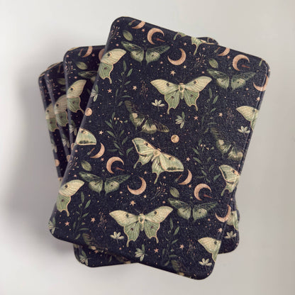 Stack of Kindle Cases with a luna moth moon design 