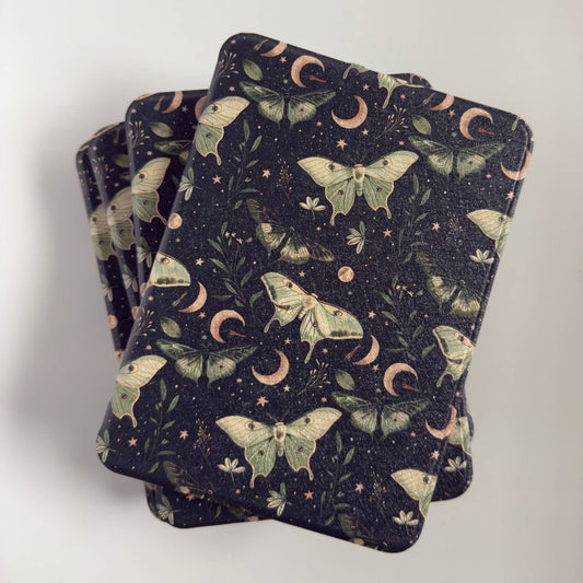 Stack of Kindle Cases with a luna moth moon design 